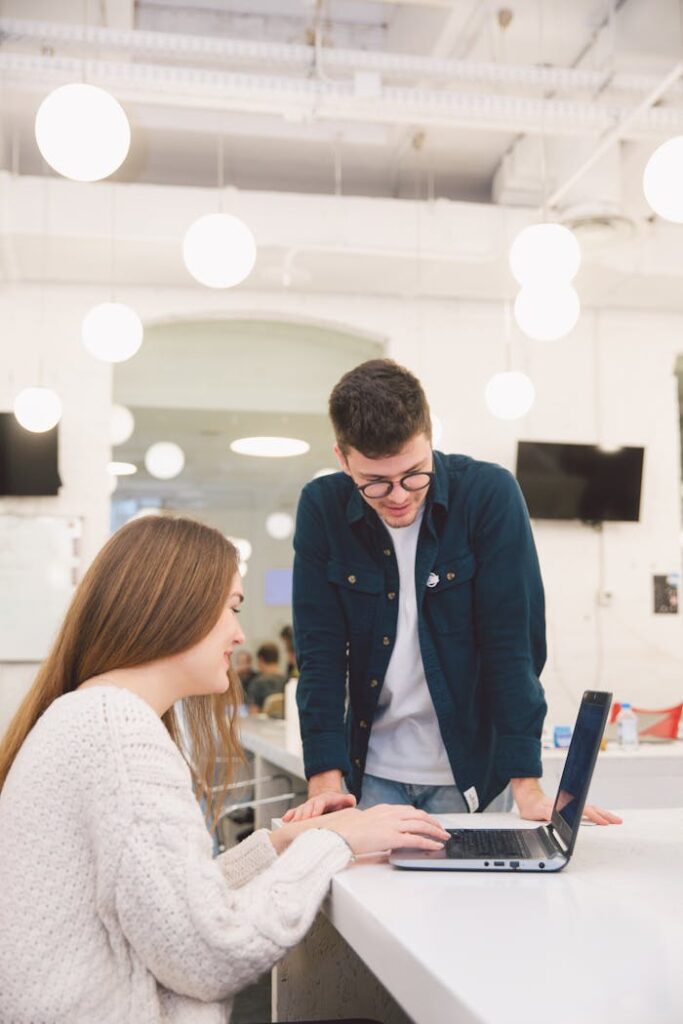 Woman and man looking at a laptop